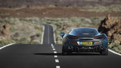 Mclaren 570gt road rear view 4k wallpaper
