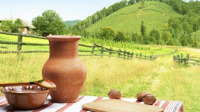 Table plate spoon jug landscape still life fence grass hills road house 4k wallpaper