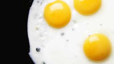 Egg yolks three fried eggs black background 4k wallpaper