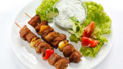 Kebabs mayonnaise cabbage cucumbers tomatoes plate white background 4k wallpaper