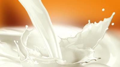 Milk spray stream orange background 4k wallpaper
