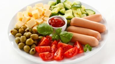 Plate slices cheese sausages olives tomatoes cucumbers ketchup leaves 4k wallpaper