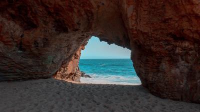 Beach rock cave 4k wallpaper
