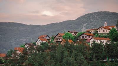 Buildings hill trees 4k wallpaper