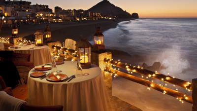 Evening table dinner restaurant coast look fires garlan 4k wallpaper