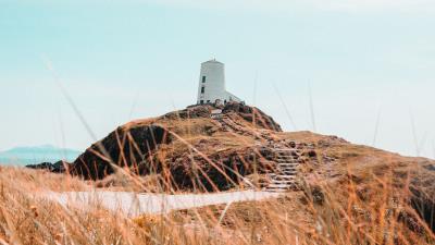 Hill lighthouse grass 4k wallpaper