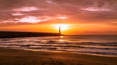 Lighthouse sea sunset 4k wallpaper