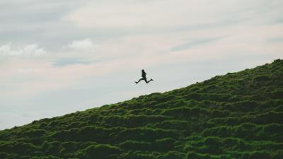 Man jump minimalism sky grass 4k wallpaper
