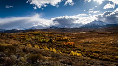 Mountains grass clouds 4k wallpaper