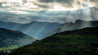 Mountains peaks rays 4k wallpaper