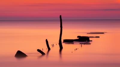 Ocean sunset sticks 4k wallpaper