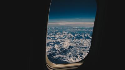 Porthole airplane mountains 4k wallpaper