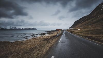 Road mountain overcast clouds 4k wallpaper