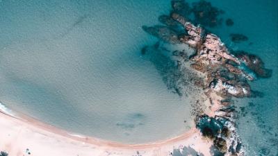 Rocks beach sand 4k wallpaper