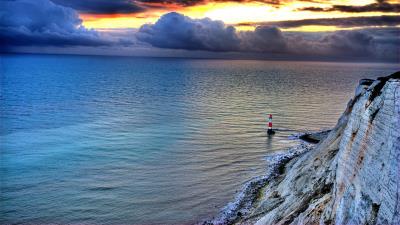 Sea lighthouse rock sunset 4k wallpaper
