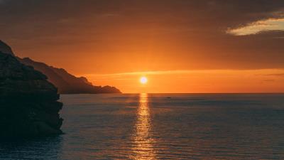 Sunset rocks glare 4k wallpaper