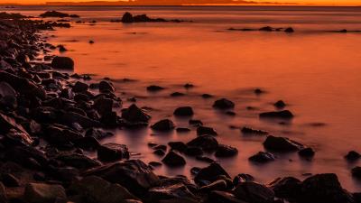 Sunset stones water 4k wallpaper