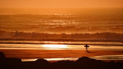 Surfer waves sunset ocean 4k wallpaper