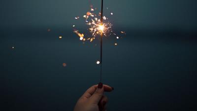 Sparklers sparks hand 4k wallpaper