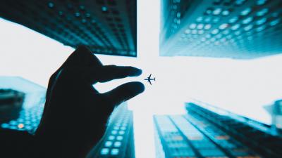 Airplane hand buildings 4k wallpaper