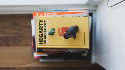 Books stack figurines 4k wallpaper