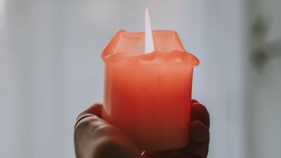 Candle fire hand 4k wallpaper