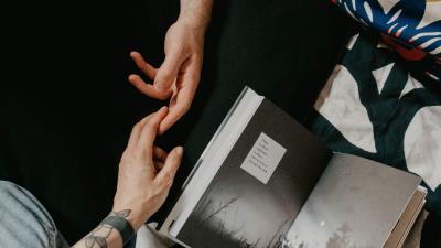 Hands tattoo book 4k wallpaper