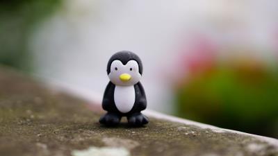 Penguin toy figurine 4k wallpaper