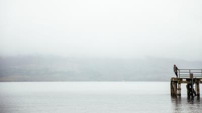 Pier man lake 4k wallpaper