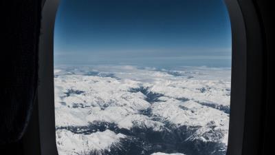 Porthole airplane window mountains 4k wallpaper