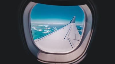 Porthole airplane wing sky 4k wallpaper
