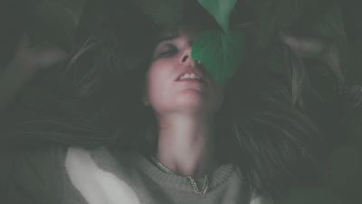 Women lying down green leaves closed eyes diffused 8k wallpaper