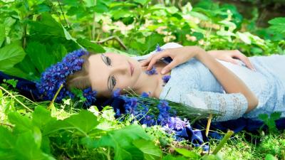 Beautiful woman laying in the grass 8k wallpaper