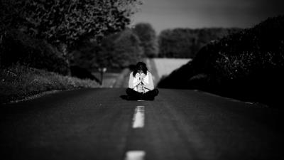 Girl meditating in the middle of the road 8k wallpaper