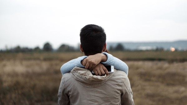 Couple Hugs Hands Back Wallpaper